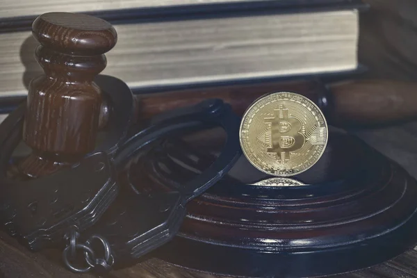 Bitcoin, judge's hammer, handcuffs. Concept bitcoin ban, violation of the law. Stock Picture