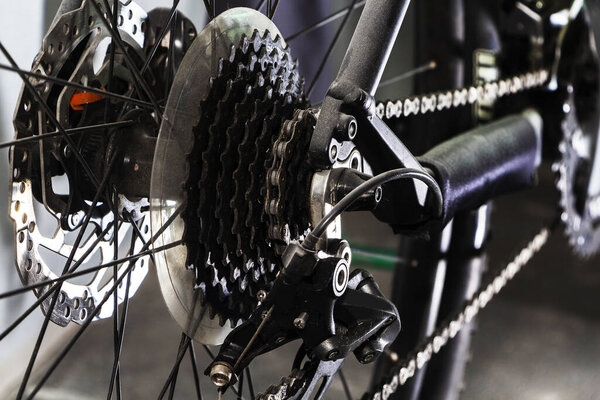 Closeup of a bicycle gears mechanism and chain on the rear wheel of mountain bike. Rear wheel cassette from a mountain bike. Close up detailed view