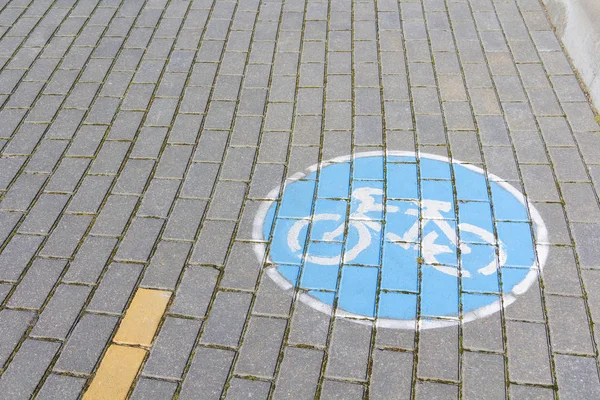 bike path and bike path sign on sidewalk tile