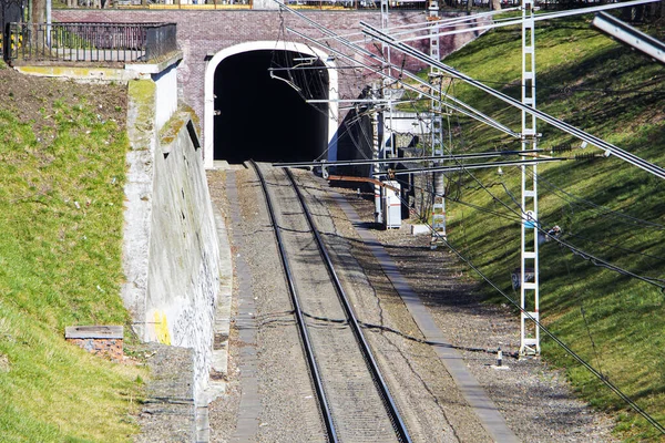 old railway tunnel crossing for trains, light at the end of the tunnel, exit from the tunnel