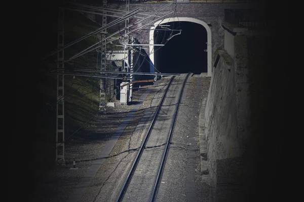 Old railway tunnel crossing for trains, light at the end of the tunnel, exit from the tunnel. — Stock Photo, Image