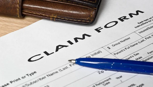 Claim form on a wooden surface — Stock Photo, Image