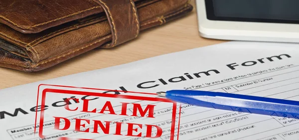 Medical claim form on a wooden surface — Stock Photo, Image