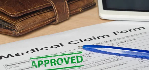 Medical claim form on a wooden surface — Stock Photo, Image