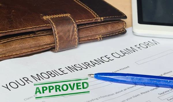 Your mobile insurance claim form on a wooden surface. — Stock Photo, Image