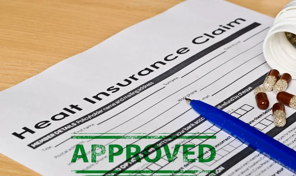 healt insurance claim form on a wooden surface
