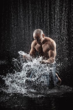 very muscular handsome athletic man in the rain clipart