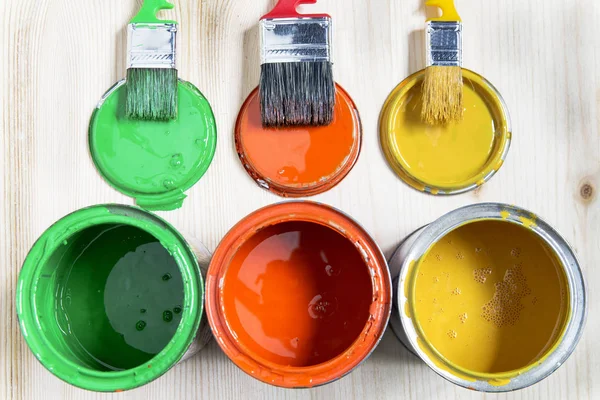 Brushes and cans with paint — Stock Photo, Image
