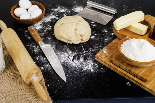 Ingredients for baking buns on black table — Stock Photo, Image