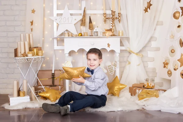 Маленький мальчик в золотых рождественских украшениях — стоковое фото