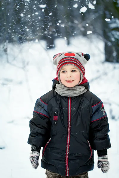 Happy laughing boy in a beautiful snowy winter forest — Stock Photo, Image