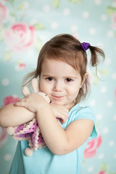 Little girl playing with her knitted toys — Stock Photo, Image