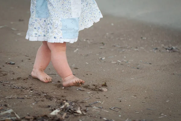 Şirin bebek kızlar bacaklar bir plajda