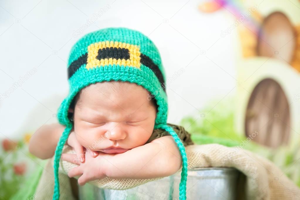 Sleeping newborn baby in a St. Patricks Day hat