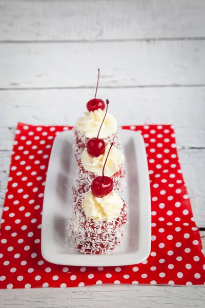 Red Cupcakes Whipped Cream Cherry Coconut Chips Red Fabric — Stock Photo, Image