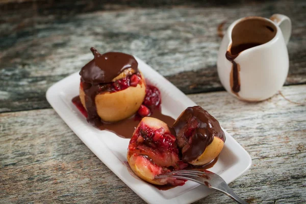 Red Baked Apples Walnuts Raspberry Pouring Chocolate Dark Wooden Background - Stock-foto