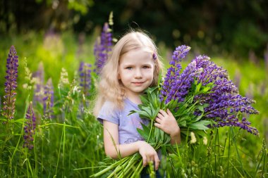 Mor acı bakla çiçek bir buket ile şirin kız