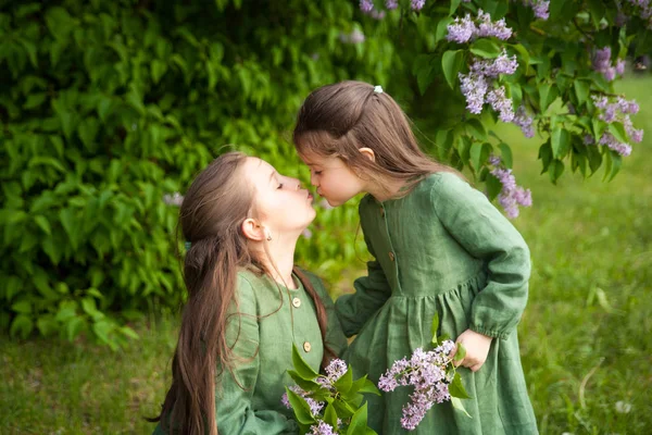Duas Irmãs Vestido Linho Verde Divertir Parque Com Lilases Floridos — Fotografia de Stock