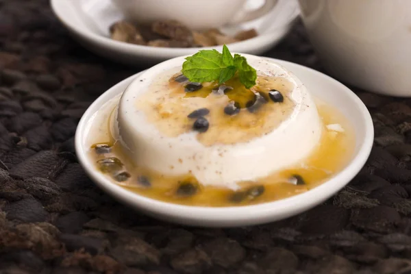 Panna cotta dessert with passion fruit and mint — Stock Photo, Image