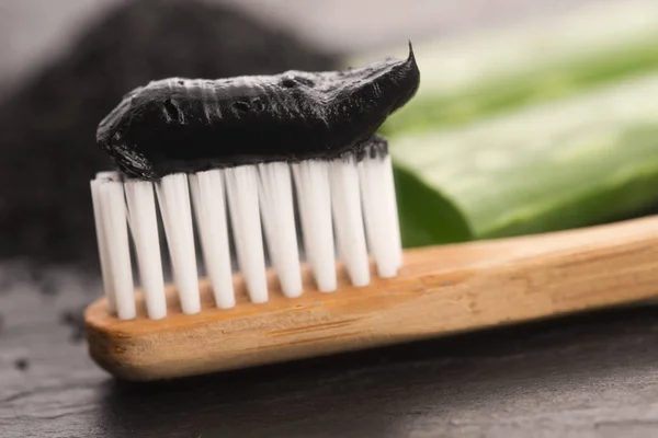 Toothbrush with black charcoal toothpaste with aloe vera
