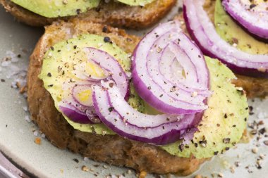 Taze avokado ve soğanlı sandviç.