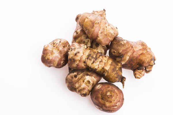 Raw Whole ans sliced Jerusalem artichokes on a white background — Stock Photo, Image