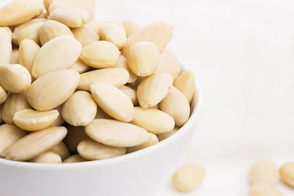 Bowl of almonds on a white background — Stock Photo, Image