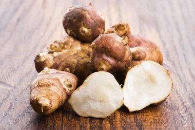 Çiğ bütün Kudüs enginarlarını kesme tahtasında dilimledi.