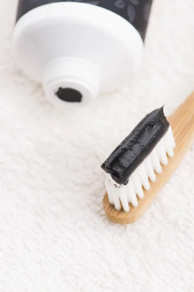 Toothbrush with black charcoal toothpaste — Stock Photo, Image