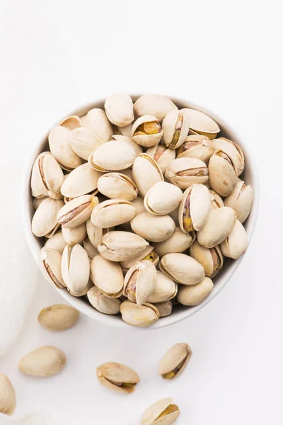 Bowl of roasted pistachios on a white background — Stock Photo, Image