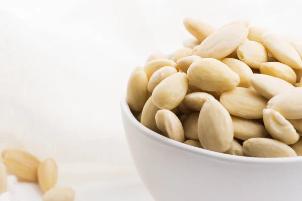 Bowl of almonds on a white background — Stock Photo, Image