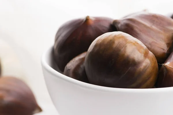 Bowl of chestnuts on a white background — Stock Photo, Image
