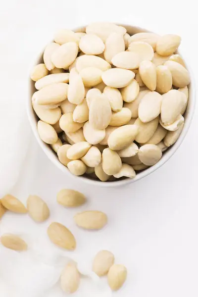 Bowl of almonds on a white background — Stock Photo, Image