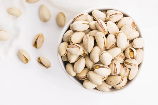 Bowl of roasted pistachios on a white background — Stock Photo, Image