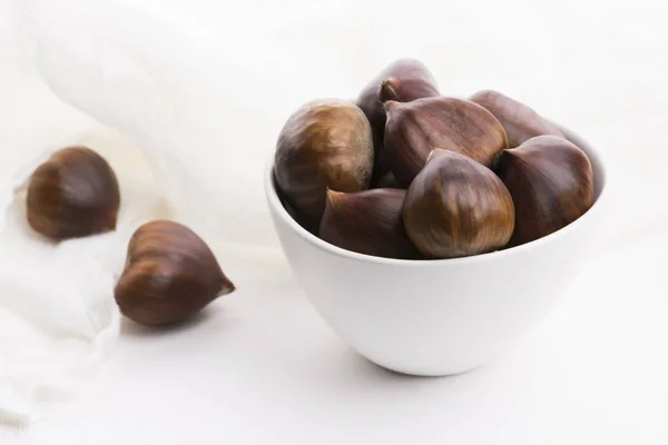 Bowl of chestnuts on a white background — Stock Photo, Image