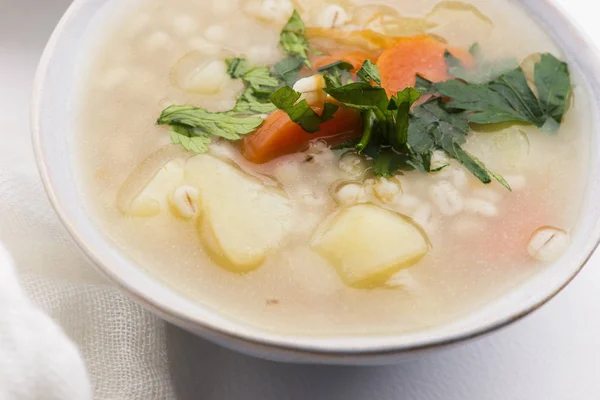 Barley soup, pearl barley in white bowl