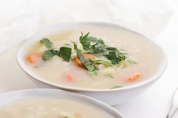 Barley soup, pearl barley in white bowl