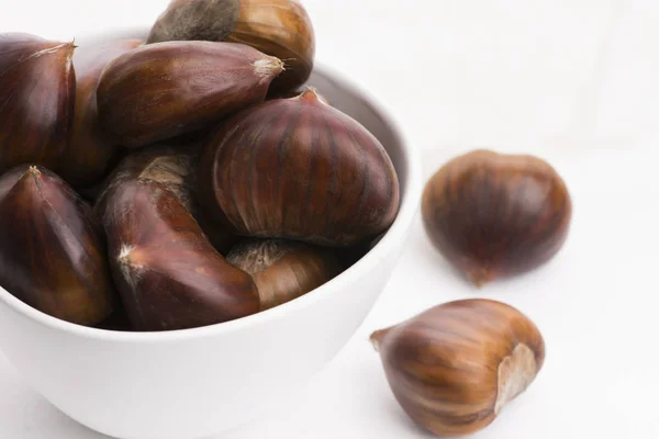 Bowl of chestnuts on a white background Royalty Free Stock Images