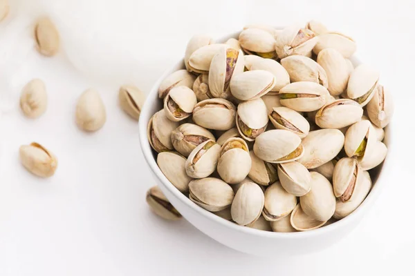 Bowl of roasted pistachios on a white background — Stock Photo, Image