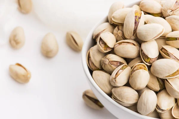 Bowl of roasted pistachios on a white background — Stock Photo, Image