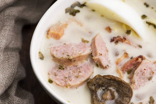 Traditional easter white borscht with eggs and sausage — Stock Photo, Image