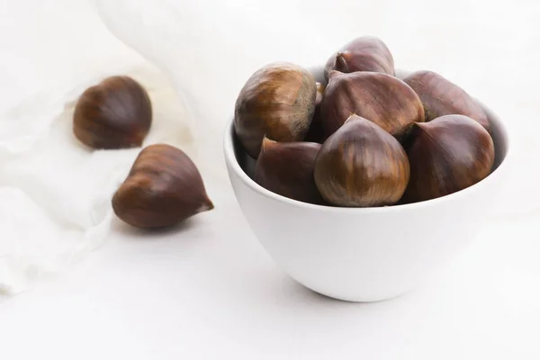 Bowl of chestnuts on a white background — Stock Photo, Image