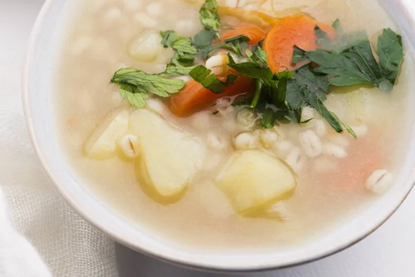 Barley soup, pearl barley in white bowl