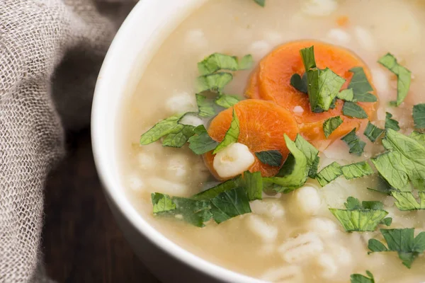 Barley soup, pearl barley in white bowl