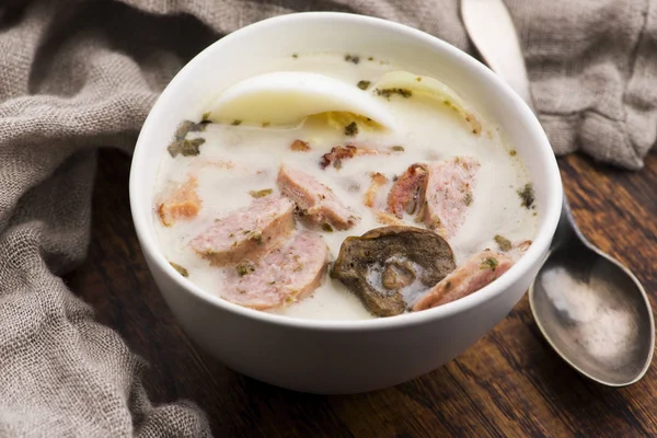 Traditional easter white borscht with eggs and sausage — Stock Photo, Image