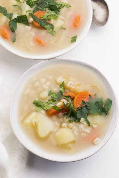 Barley soup, pearl barley in white bowl