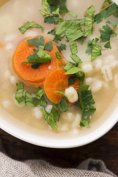 Barley soup, pearl barley in white bowl