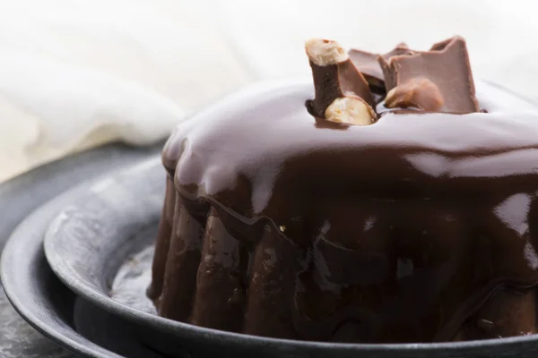 Chocolate pudding with chocolate dressing on a plate