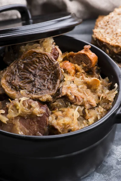 Traditional polish sauerkraut (bigos) with mushrooms and plums f