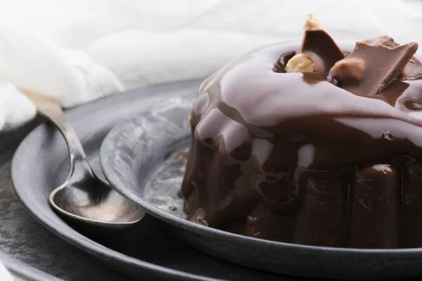 Chocolate pudding with chocolate dressing on a plate